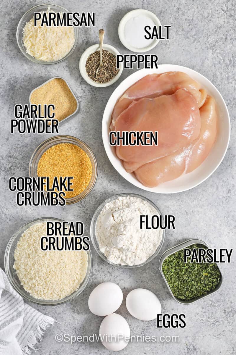 chicken , parmesan , garlic powder , cornflake crumbs , panko bread crumbs , flour , eggs , parsley , salt and pepper with labels to make Crispy Parmesan Crusted Chicken