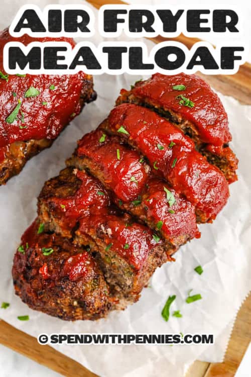 Air fryer meatloaf is a quick and easy way to serve up a classic comfort food with less mess. Made with lean ground beef, bell pepper, onion, breadcrumbs, and savory seasonings, these mini loaves cook up tender inside with a flavorful crust. A tangy tomato-chili topping adds the perfect finish. Ready in about 30 minutes, it’s a simple dinner the whole family will love. #spendwithpennies juicy Air Fryer Meatloaf cut into slices with a title