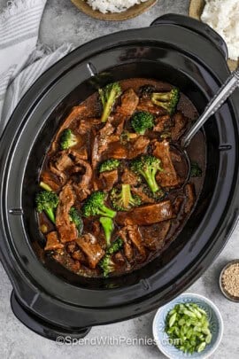 slow cooker with Slow Cooker Beef and Broccoli and a spoon
