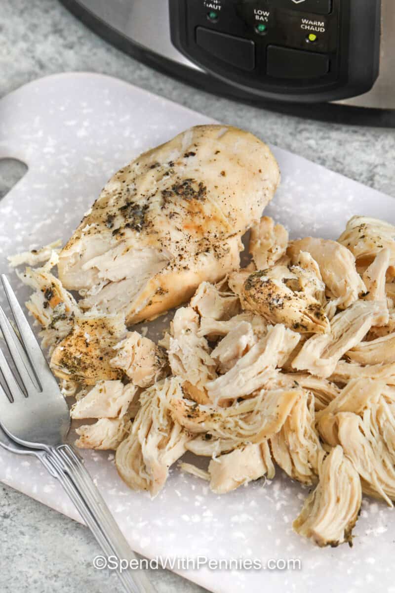 shredding cooked chicken to make Slow Cooker Chicken Stew