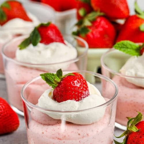 glasses of Strawberry Mousse with strawberries around it