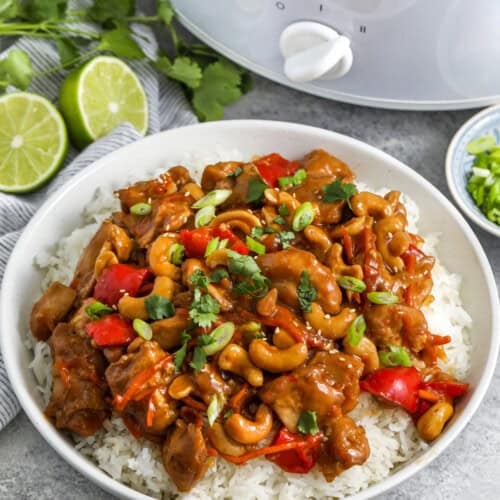 Crockpot Cashew Chicken on rice and pot full in the back