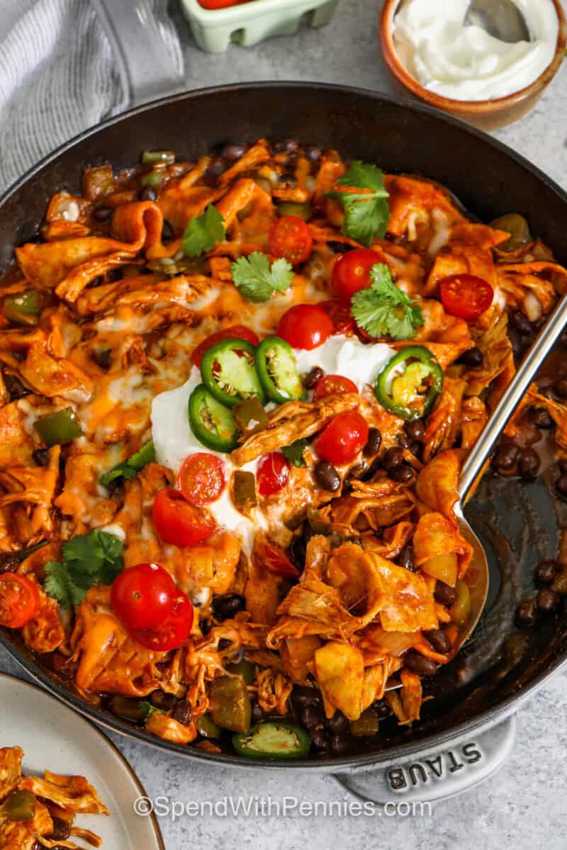 Enchilada Skillet in the pan with a spoon