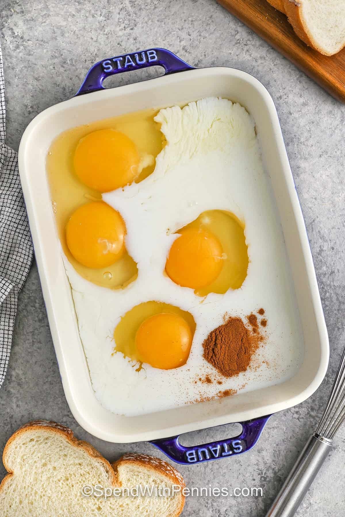 adding cinnamon and milk to eggs to make French Toast Recipe