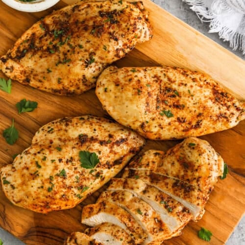 Oven Baked Chicken Breasts on a wooden board