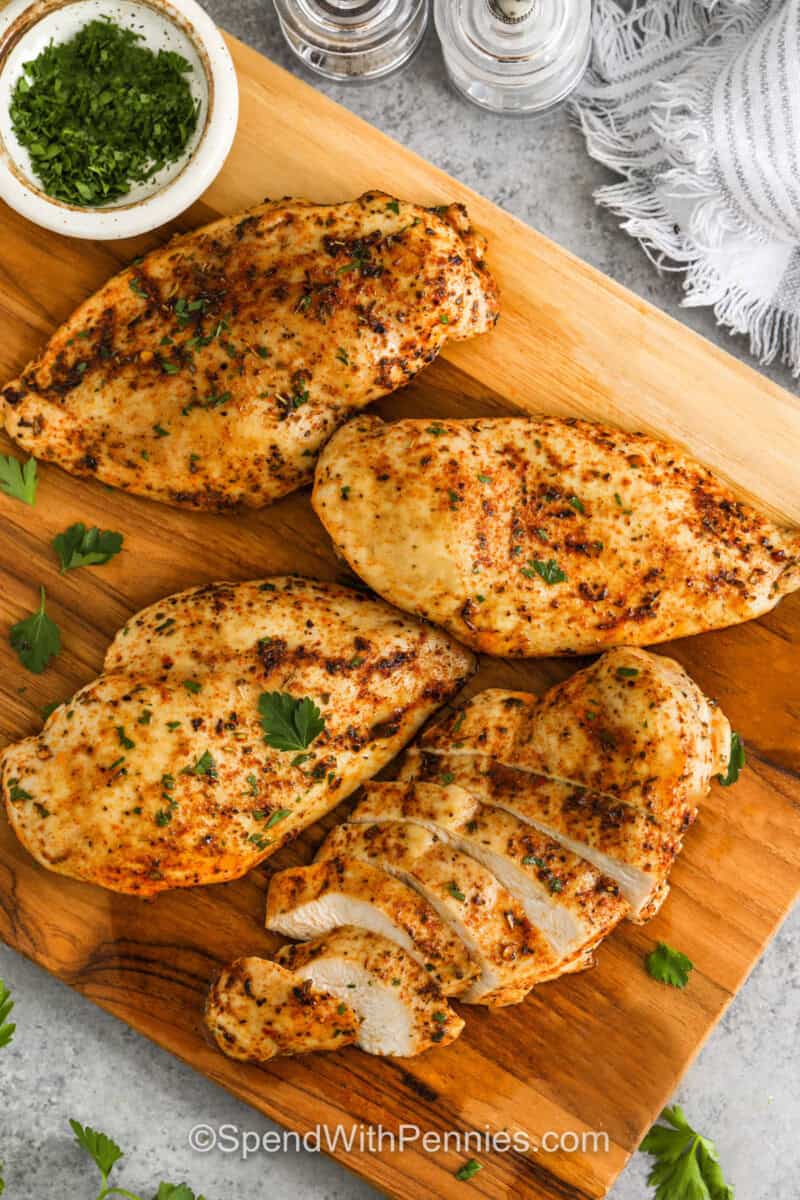 Oven Baked Chicken Breasts on a wooden board