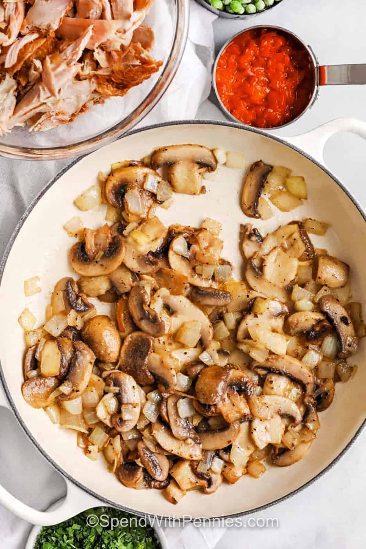 onions and mushrooms cooking in a pan to make Chicken a la King