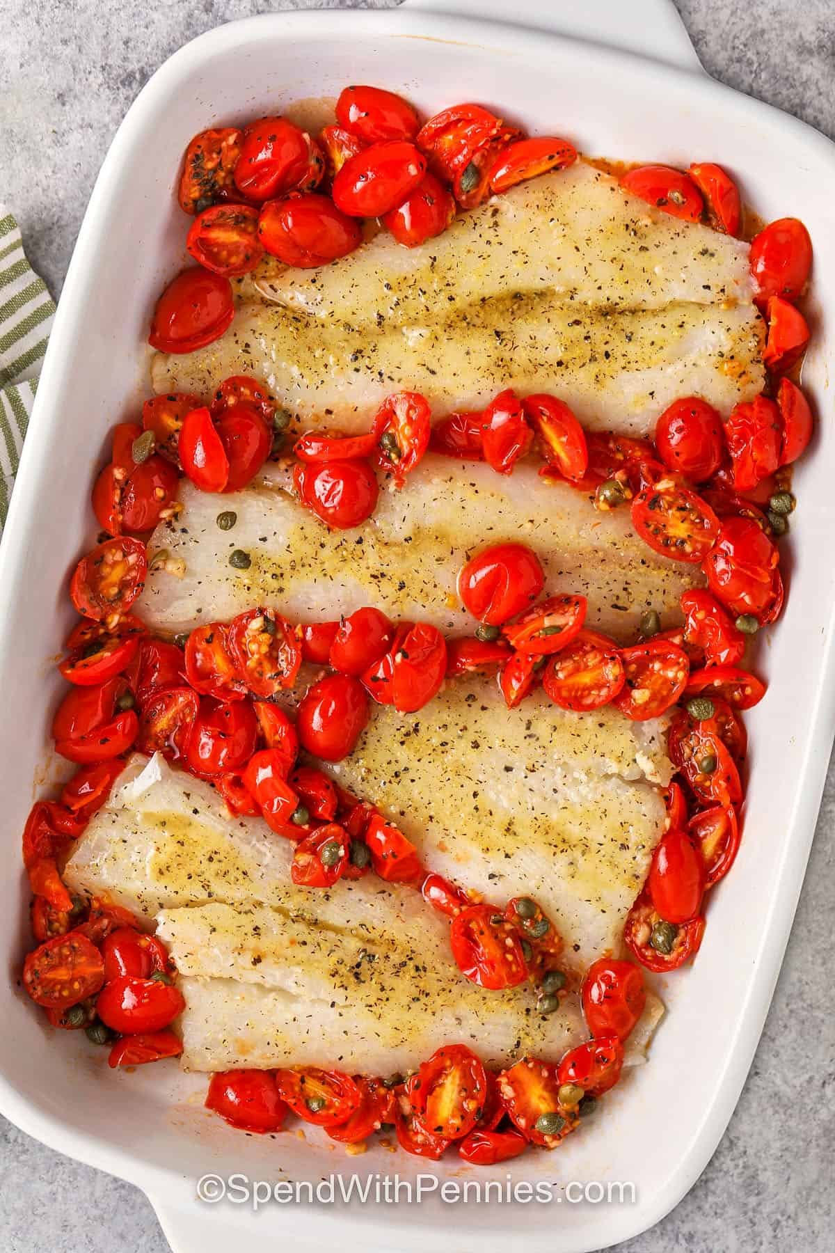 Grilled cod with tomatoes is a simple seafood dish filled with fresh savory flavors. The cod is marinated in lemon juice and olive oil and baked with garlic-spiced tomatoes and brick prickly pickles. Its melted butter and fresh herbs enjoy a restaurant-quality flavor at home. Soak the juice in crusty bread or a side of rice! #spendwithpennies Add cod to the tomatoes in the dish, so the roasted cod and tomatoes