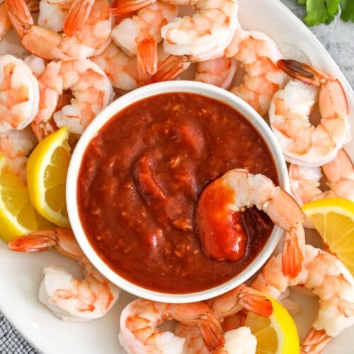 plated Cocktail Sauce with shrimp and lemon slices