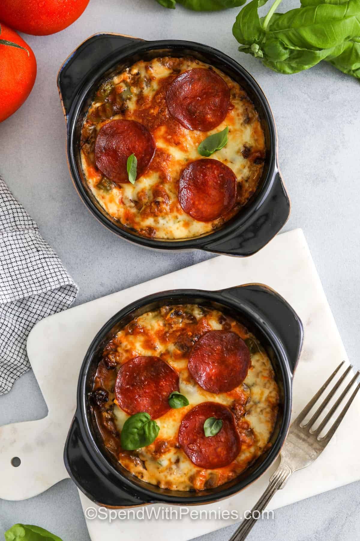 Try a cottage cheese pizza bowl for a cozy and filling meal that skips the crust but not the flavor. Savory sausage, cooked veggies, and creamy cottage cheese come together under a rich layer of pizza sauce and gooey melted cheese. It’s easy to make, easy to love, and easy to make your own with all your favorite toppings. Serve it straight from the oven for the best cheesy pull. #spendwithpennies top view of Cottage Cheese Pizza Bowls