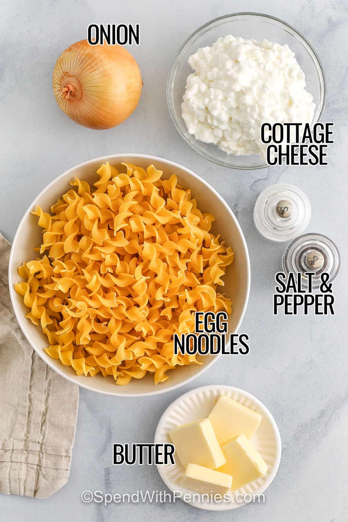 Cottage cheese and noodles are a creamy and easy way to make dinner or a side dish feel extra special. This recipe combines boiled egg noodles, golden onion, and rich cottage cheese for a warm and satisfying bite. Want to add a little crunch? Bake it in the oven with breadcrumbs and a bit of cheese. It’s ready for weeknight dinners, holiday tables, or cozy weekends. #spendwithpennies onion , cottage cheese , egg noodles , butter , salt and pepper with labels to make Cottage Cheese and Noodles