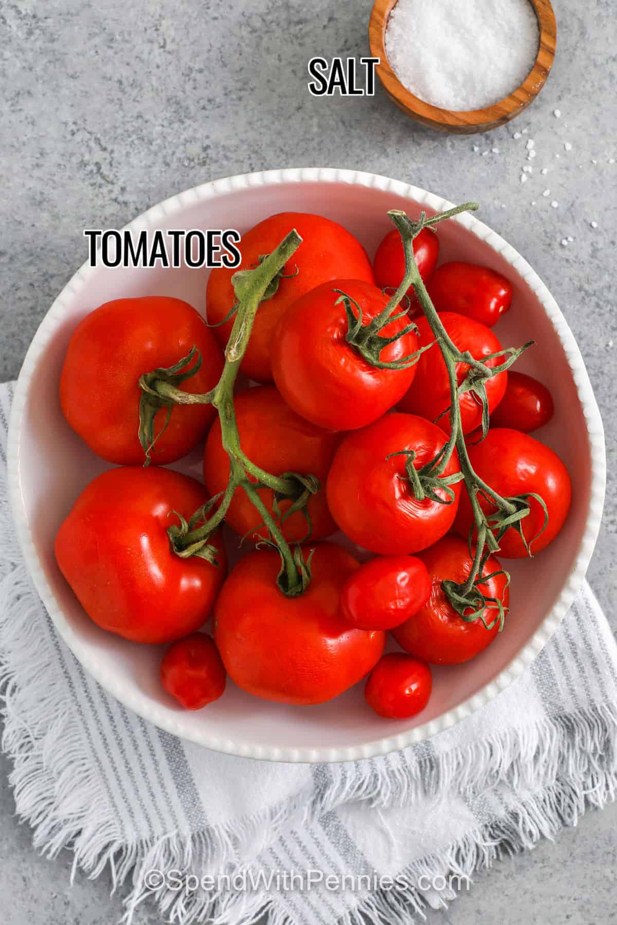 These oven-roasted sun dried tomatoes are packed with rich, concentrated flavor from Campari, Roma, or cherry tomatoes. A slow 6-hour bake brings out their natural sweetness, giving them a tender, chewy texture. Store them in olive oil with a sprinkle of basil for an irresistible, savory treat. Perfect for salads, pasta, or sandwiches, they’re simple, delicious, and budget-friendly. A great way to enjoy tomatoes all year long! #spendwithpennies tomatoes and salt with labels to make Sun Dried Tomatoes