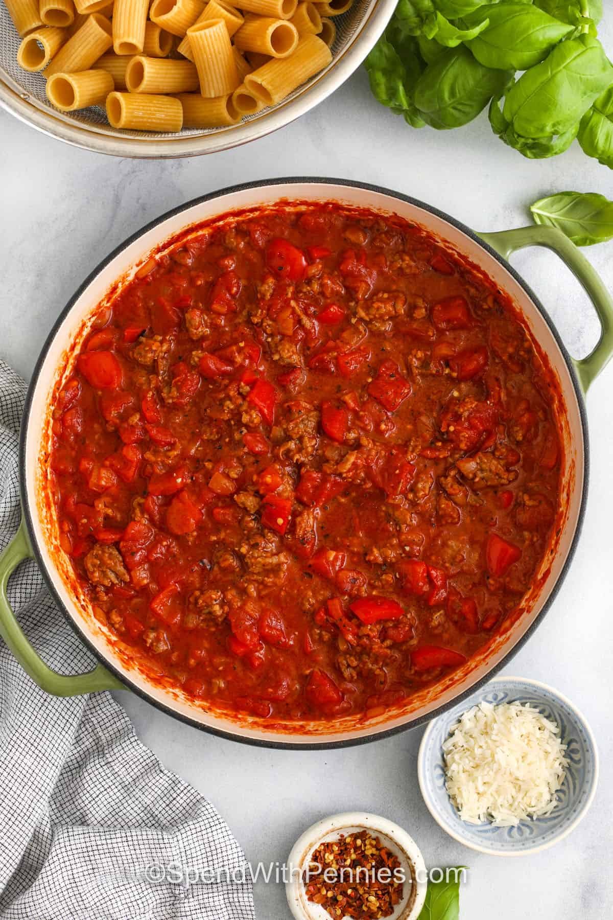 Italian sausage pasta is bold, hearty and full of flavor and the whole family will love it. Juicy sausage, tender pasta and fire-roasted red peppers gather together. A simple tomato-based sauce tie them together every time to make it a perfect bite. Add a bunch of parmesan cheese and some fresh basil to dinner, just like your favorite Trattoria. Comfortable food becomes easy and always takes a hit. #spendwithpennies Italian sausage pasta in the pot