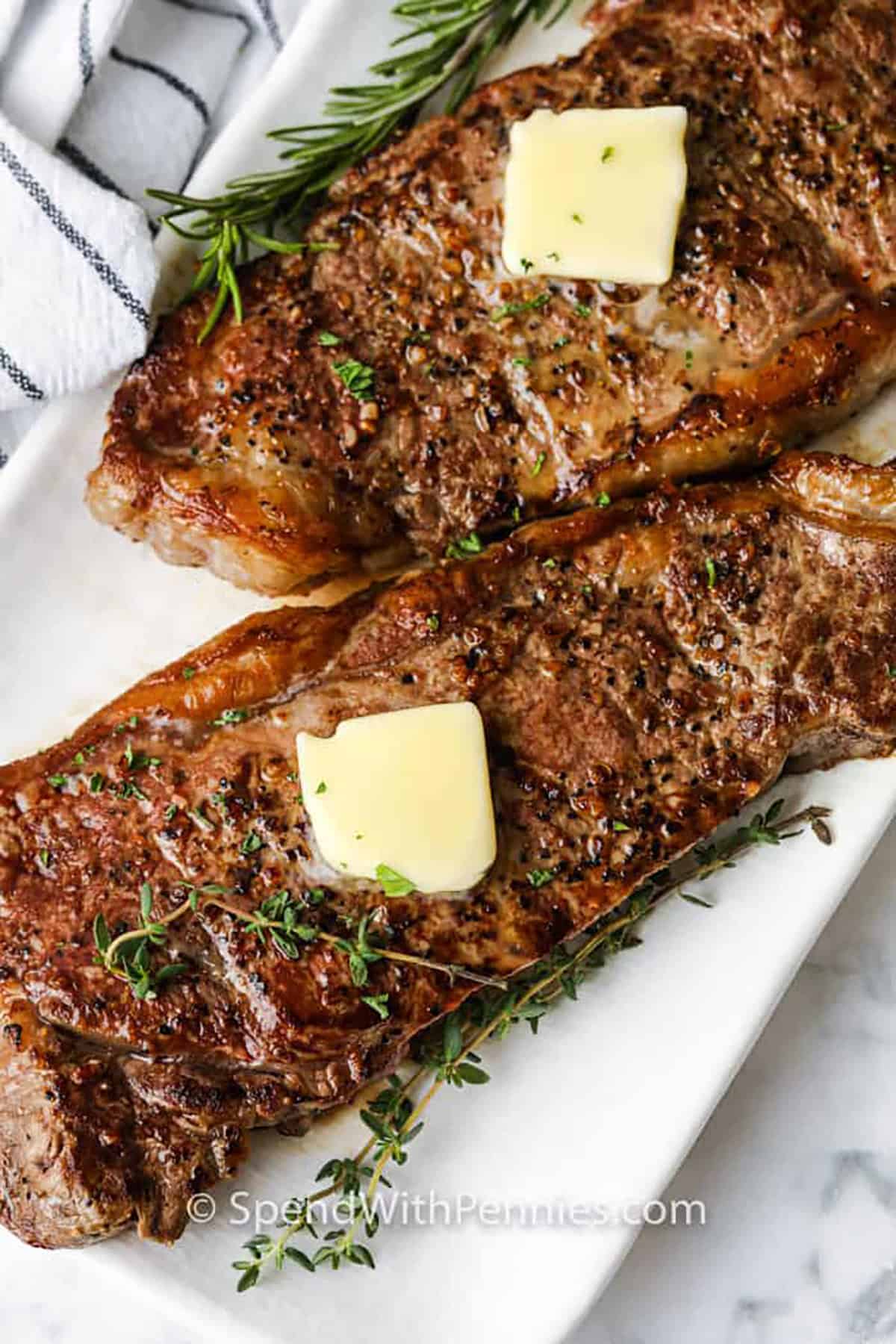 Cooking juicy steak in the oven takes just a few easy steps using thick ribeyes, olive oil, and simple seasoning. Pan-searing gives a beautiful crust, and the oven finish keeps them tender inside. A touch of butter adds richness, while the optional pan sauce brings bold, savory flavor. Let steaks rest before serving for the best results. #spendwithpennies Juicy Oven Steak with butter