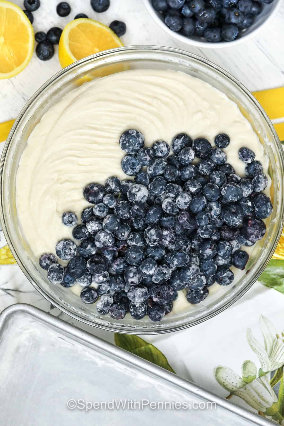 adding blueberries to Lemon Blueberry Cake batter in a bowl