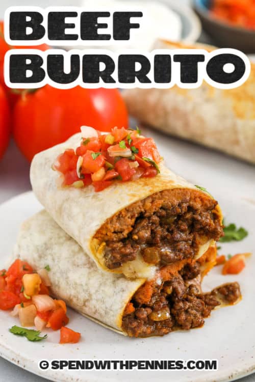 This favorite beef burrito recipe is packed with flavor and so easy to make. Lean ground beef is cooked with taco seasoning and onions until perfectly tender, then wrapped in warm tortillas with creamy refried beans and melty pepper jack cheese. Add fresh cilantro for a pop of brightness. Toast the burritos in a skillet for a golden, crispy finish. They’re filling, flavorful, and freezer-friendly—perfect for meal prep or busy nights! #spendwithpennies Beef Burrito Recipe sliced on a plate with pico de gallo and writing