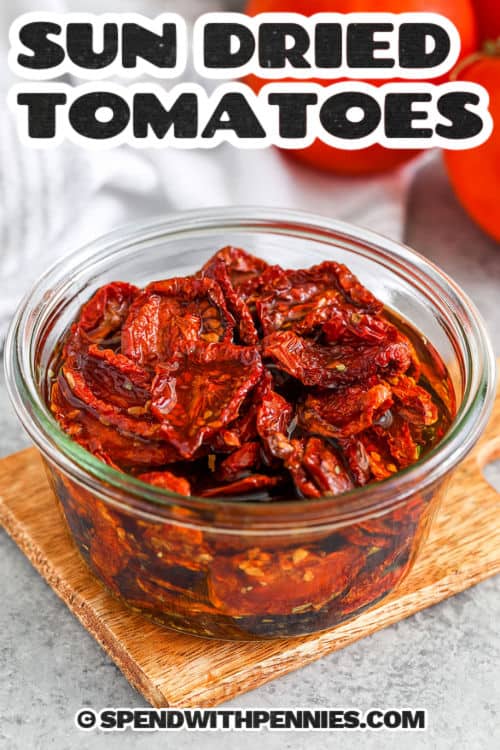 These oven-roasted sun dried tomatoes are packed with rich, concentrated flavor from Campari, Roma, or cherry tomatoes. A slow 6-hour bake brings out their natural sweetness, giving them a tender, chewy texture. Store them in olive oil with a sprinkle of basil for an irresistible, savory treat. Perfect for salads, pasta, or sandwiches, they’re simple, delicious, and budget-friendly. A great way to enjoy tomatoes all year long! #spendwithpennies bowl of Sun Dried Tomatoes with a title