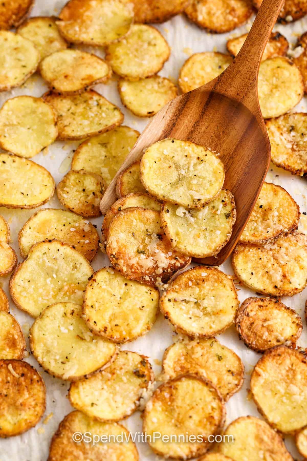 taking Oven Baked Potato Slices out of a sheet pan