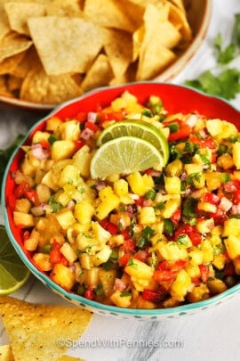 tangy Pineapple Salsa in a bowl with a bowl of chips