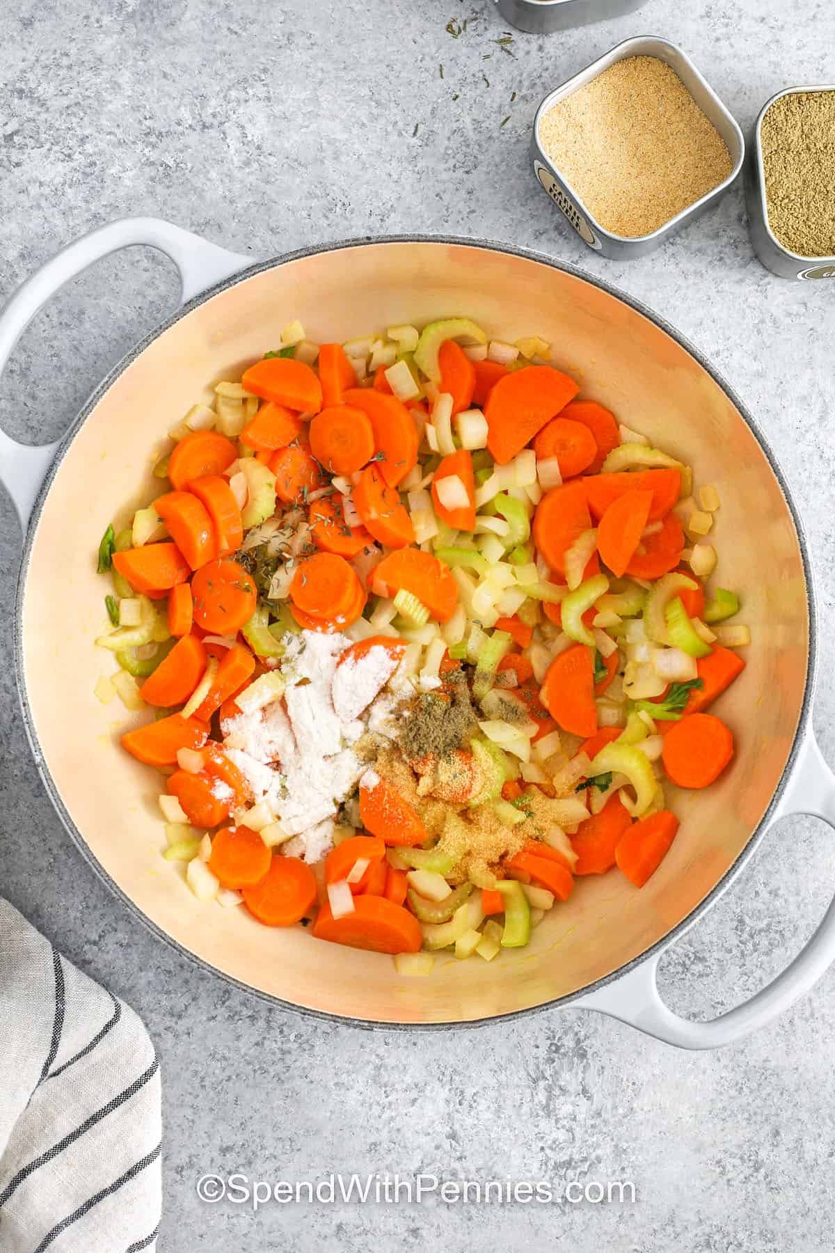 adding flour and seasonings to veggies in pot to make Rotisserie Chicken Soup