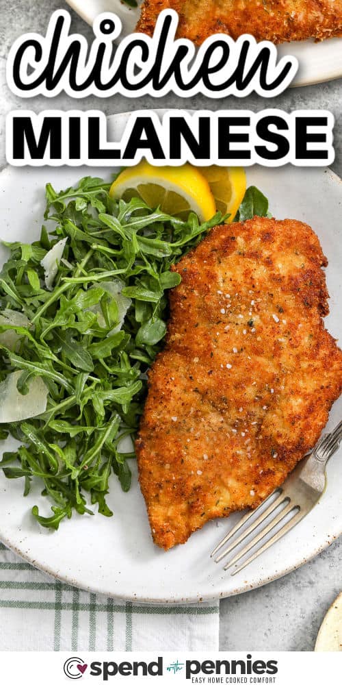 plate of Chicken Milanese with salad and lemon slices with writing