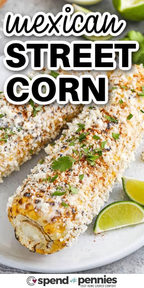 Mexican Street Corn on a plate with lime wedges and title