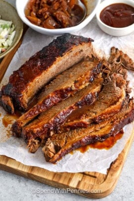 Slow Cooker Brisket on a cutting board cut into slices
