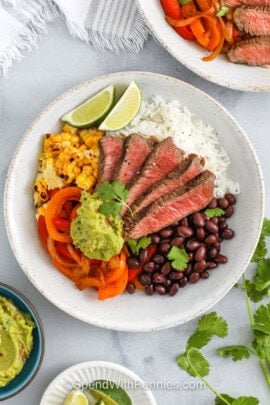 Steak Bowls with rice , beans , corn , peppers and guacamole