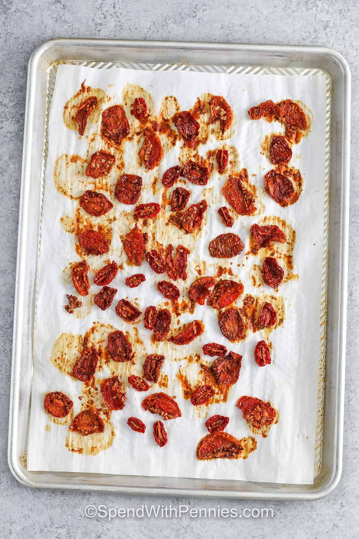 There’s nothing like the bold, savory punch of sun dried tomatoes, and this simple recipe brings it home with just a handful of ingredients. Slice tomatoes evenly, slow roast for hours, then finish in olive oil and basil for classic flavor. The texture is chewy, not brittle, and the taste is robust. Add to creamy dips, grilled sandwiches, or grain bowls for a pop of sun-kissed flavor! #spendwithpennies Sun Dried Tomatoes on a sheet pan