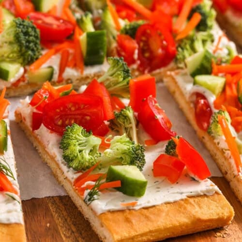 veggie pizza slices on a wooden serving tray