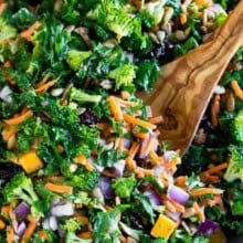 Easy Kale Salad with Fresh Lemon Dressing in a bowl with a wooden spoon