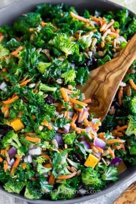 Easy Kale Salad with Fresh Lemon Dressing in a bowl with a wooden spoon
