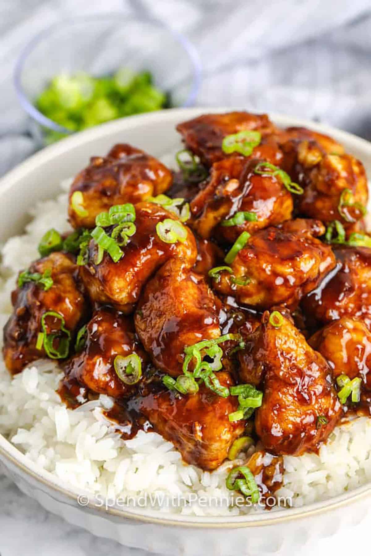 General Tso’s chicken is a bold and spicy recipe that’s just as good as your favorite Chinese takeout. Crispy fried chicken pieces are coated in a thick, sticky sauce with soy, hoisin, garlic, and a touch of heat. This dish is packed with layers of flavor, and when served with rice or stir-fried veggies, it’s always a hit. Try it for dinner and serve with with steamed rice or boiled noodles. Or, cut a few calories and serve it on cooked shredded cabbage. #spendwithpennies plated General Tso's Chicken with rice