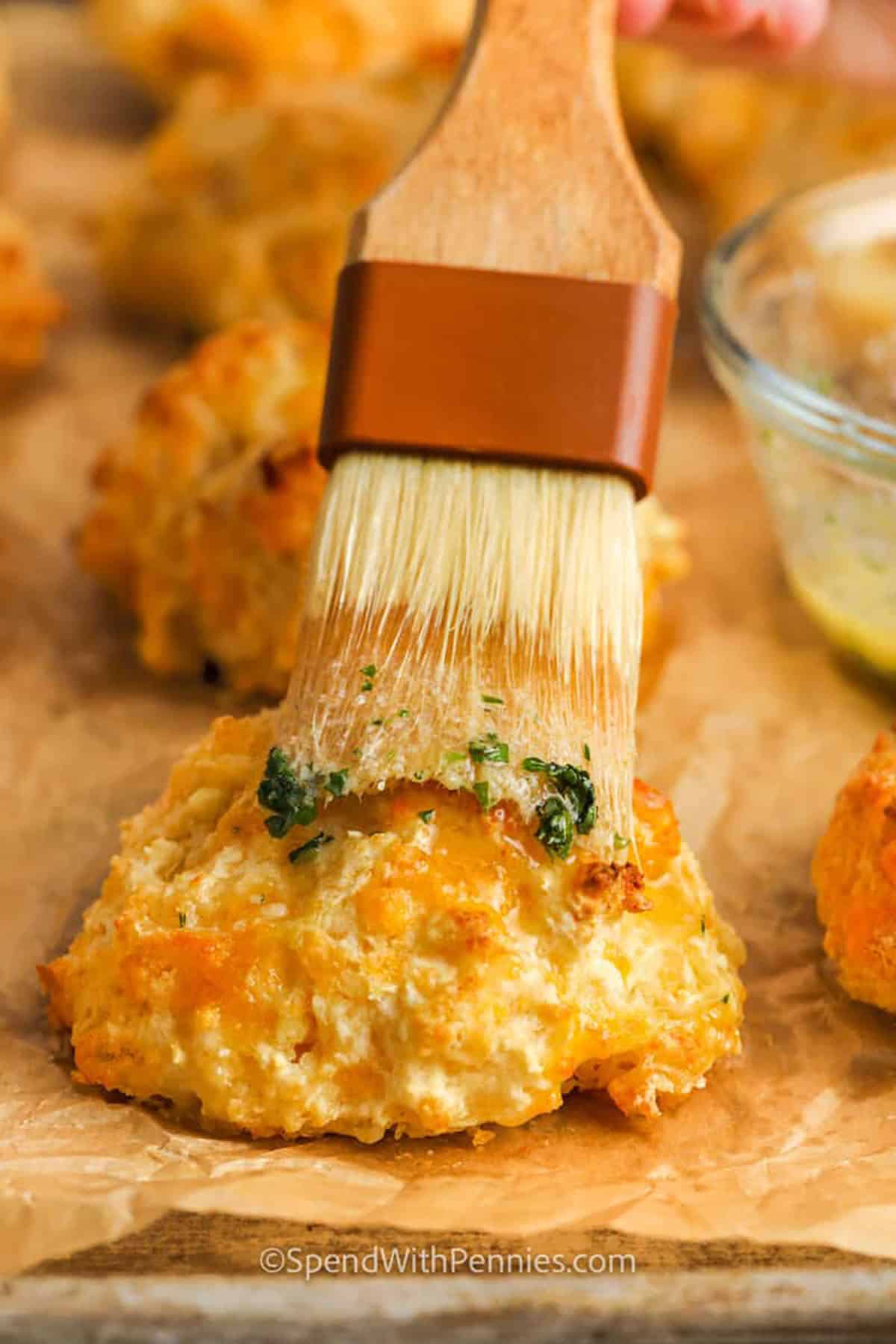 brushing butter over Red Lobster Cheddar Bay