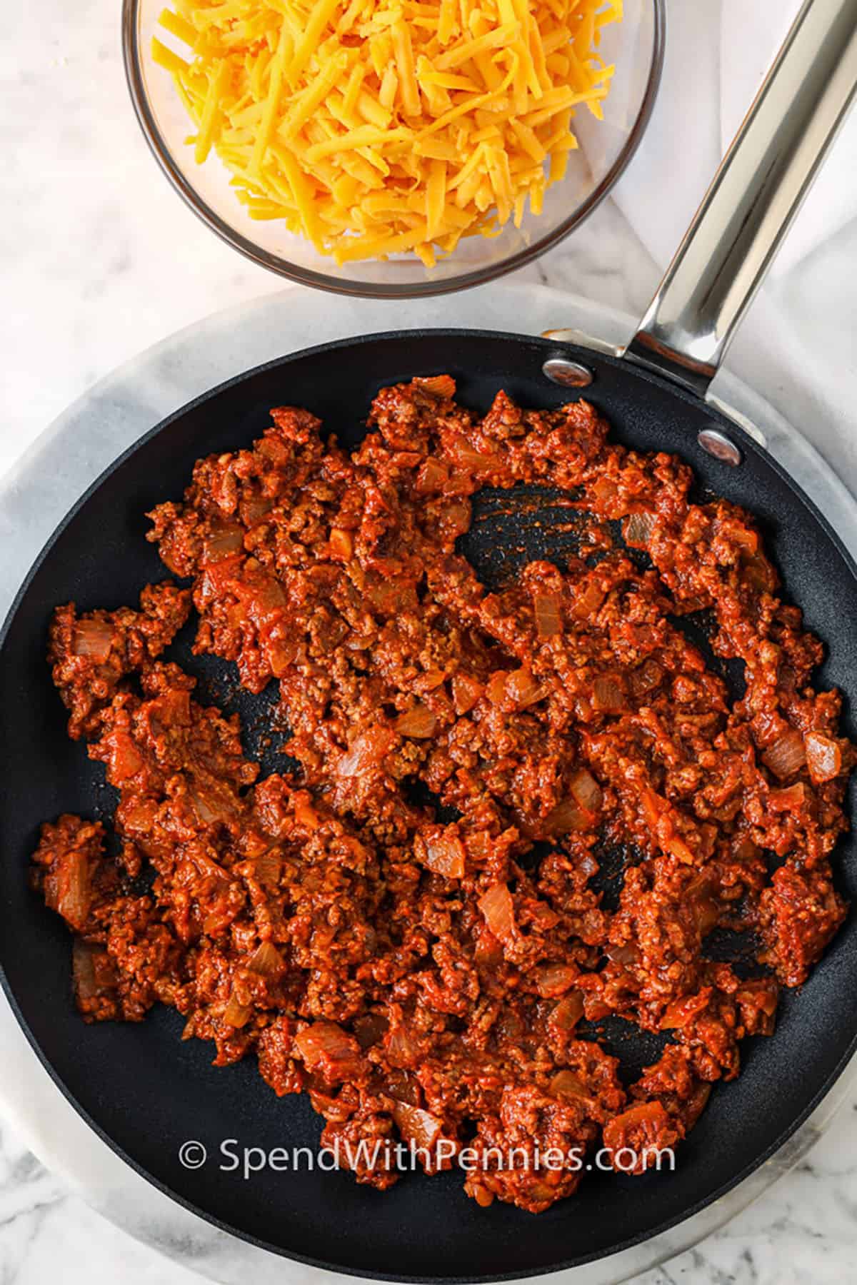 Chili cheese dogs are a hot recipe that checks all the boxes—hearty, cheesy, baked, and full of flavor. Each bite delivers the best mix of juicy hot dog, seasoned chili, and golden melted cheddar. Make a pan for your next get-together and let everyone customize their own with toppings like jalapenos or chopped onion. Or serve it up as a chili cheese dog casserole for a potluck-friendly dish. It’s a recipe that gets requests every time. #spendwithpennies chili in a pan to make Chili Cheese Dogs