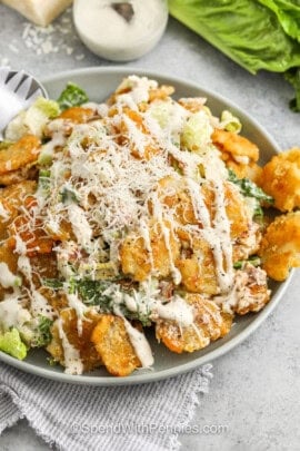 Crispy Tater Caesar Salad in a bowl with dressing