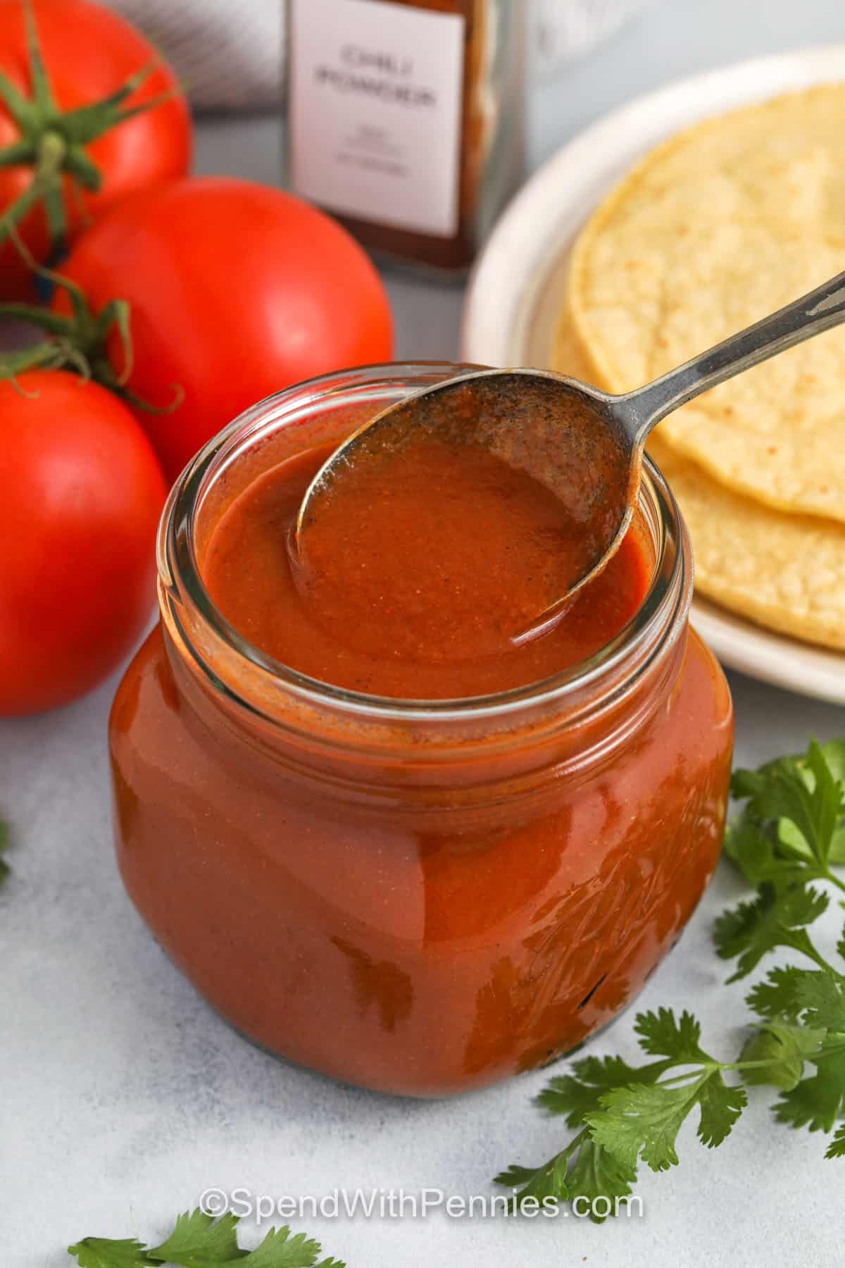 taking Enchilada Sauce out of a jar with a spoon