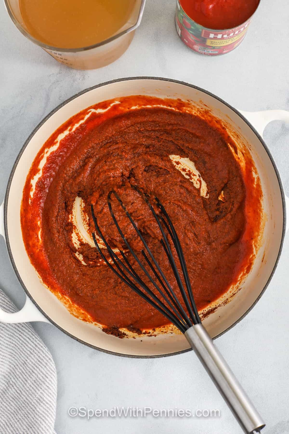 whisking ingredients together to make Enchilada Sauce