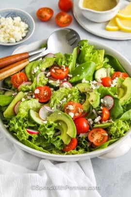 bowl of Fresh Summer Salad with dressing in the back