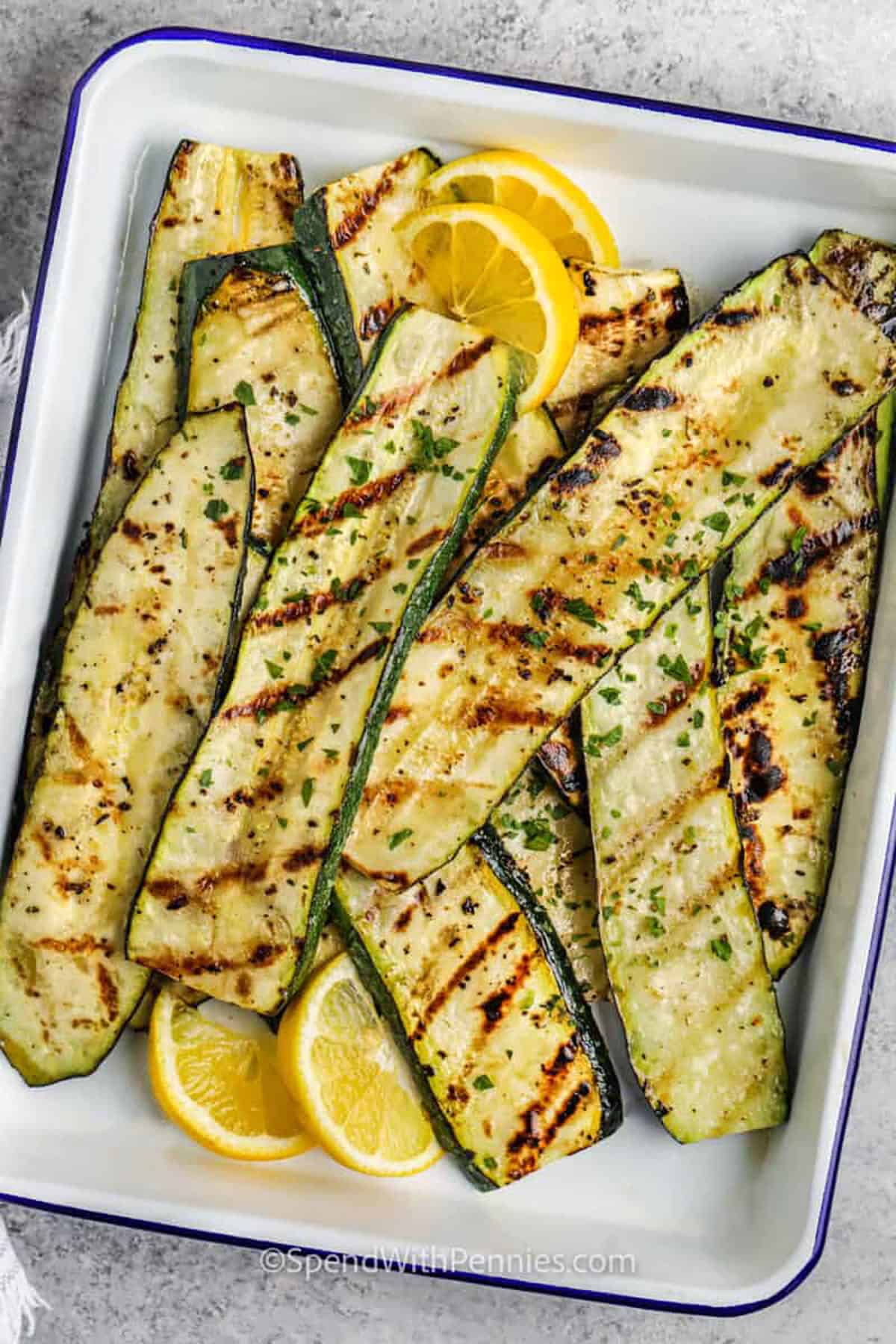 Grilled Zucchini in a dish with lemon slices