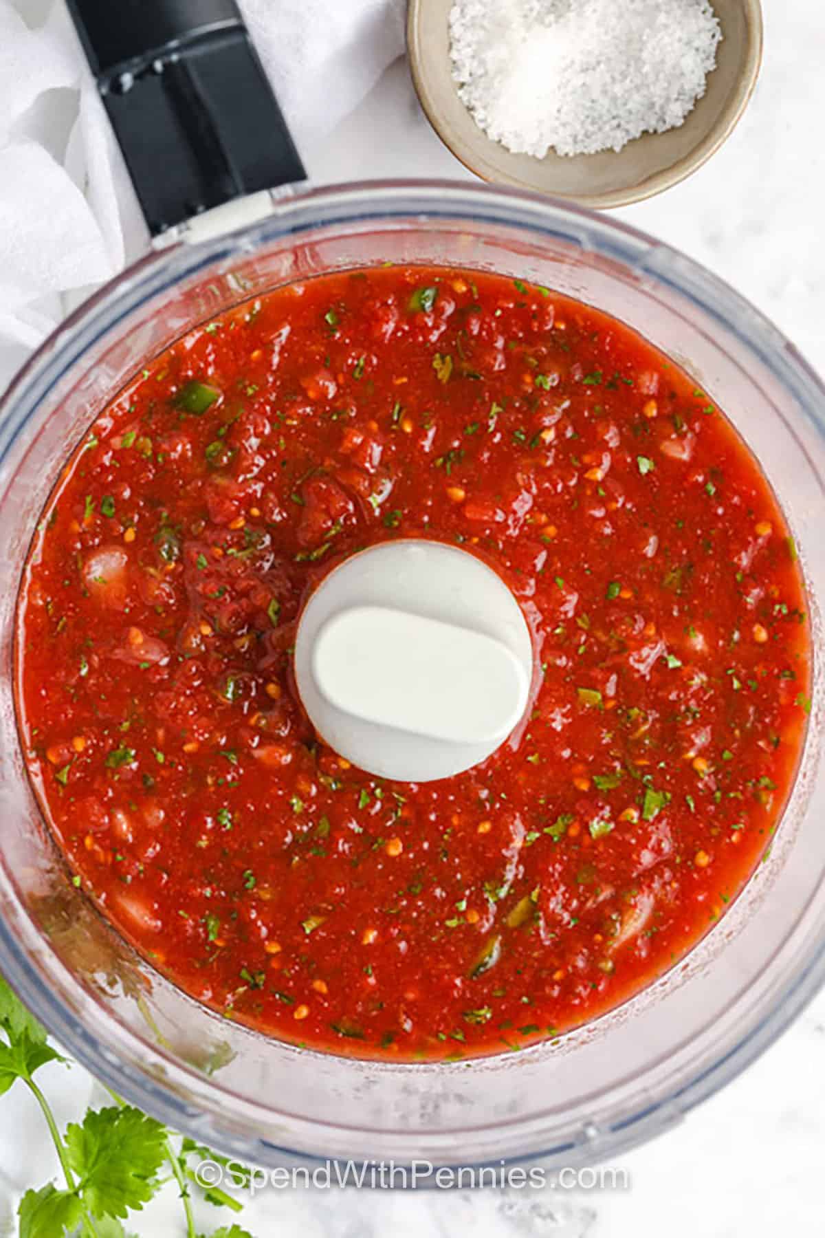 Homemade salsa is bursting with fresh flavor from canned tomatoes, jalapeño, lime, and cilantro. It’s quick to make in a food processor with just a few pulses and tastes even better after chilling. With a zesty mix of garlic, cumin, and onion, this salsa is bold, bright, and perfect for dipping or topping your favorite dishes. Ready in minutes and full of flavor! #spendwithpennies Homemade Salsa in the food processor