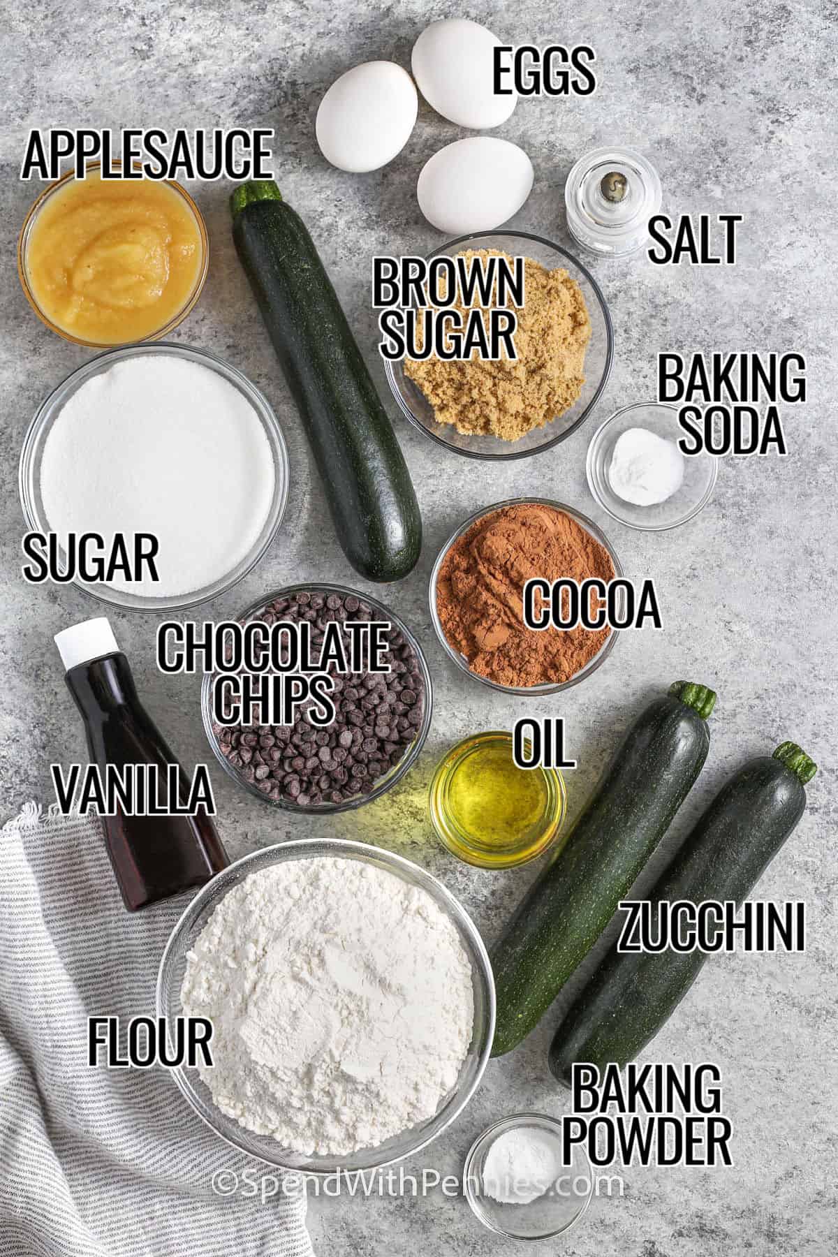Chocolate zucchini bread is a homemade favorite with the perfect mix of healthy and sweet. This easy recipe uses applesauce, rich cocoa, and chocolate chips to make a soft, moist loaf. The zucchini melts right in so you get a soft texture without tasting the veggies. Add in chopped almonds or walnuts if you like a little crunch. It’s the best way to treat yourself or share with a friend. #spendwithpennies eggs , applesauce , brown sugar , salt , baking soda , salt, sugar , cocoa , chocolate chips , vanilla , oil , flour , baking powder , zucchini with labels to make Chocolate Zucchini Bread