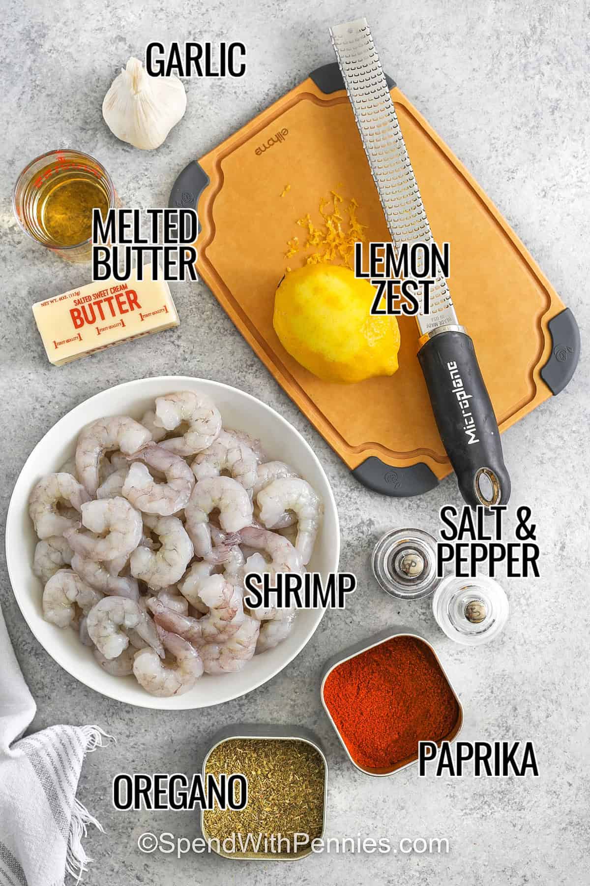 This baked shrimp recipe uses just a handful of ingredients and fills your kitchen with the smell of oven garlic. Tossed in butter and herbs, it comes out juicy and flavorful. It’s the kind of recipe that works just as well for guests as it does for busy weeknights. Whether served with rice, salad, or a side of bread, this oven baked shrimp recipe is a keeper. #spendwithpennies garlic , butter , oil , lemon zest , shrimp , oregano , paprika , salt and pepper with labels to make Oven Baked Shrimp