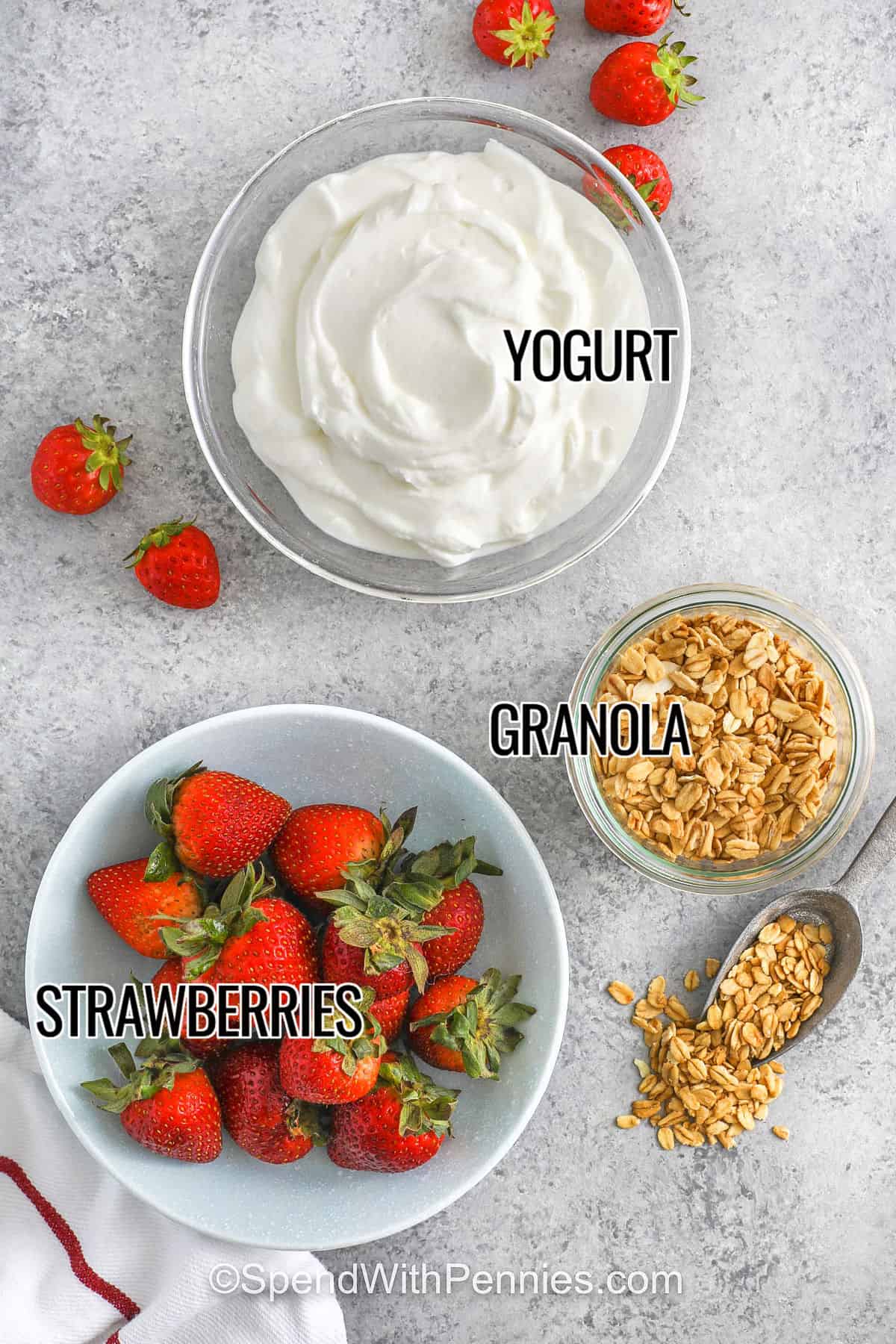 Strawberry parfaits are an easy breakfast or snack to make in minutes with just three simple ingredients. Juicy strawberries are layered with vanilla yogurt and crunchy granola in jars or glasses, ready to enjoy right away or grab and go for a mid-morning snack. This wholesome, energizing treat will keep you fueled all morning long. Vary the recipe. Try blueberry or raspberry, or make it a dessert by layering chocolate pudding or jello with whipped cream.#spendwithpennies yogurt , granola , strawberries with labels to make Strawberry Parfait
