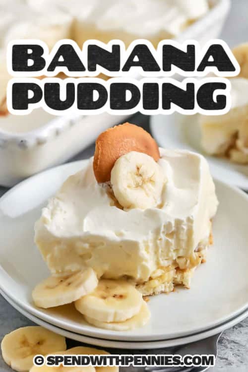 Banana pudding is that sweet and creamy dessert that brings comfort and smiles to every bite. With layers of fresh bananas, vanilla wafers, and a rich, homemade pudding, it’s perfect for potlucks, holidays, or just because. Topped with fluffy whipped cream and chilled until everything blends together just right, this classic treat is always a family favorite. Simple ingredients, nostalgic flavor, and so easy to love. It’s always the first dessert to disappear. #spendwithpennies plated slice of Banana Pudding Recipe with cookie and banana slices on top and a title