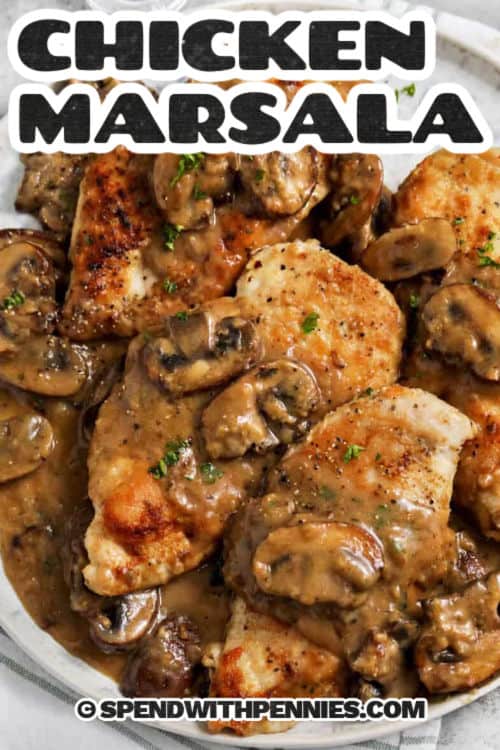 Chicken Marsala features juicy pan-fried chicken covered in a savory sauce made from Marsala wine, mushrooms, and chicken broth. Shallots and thyme give it a herby flavor, while butter adds richness. This one-skillet dish is hearty and elegant, but surprisingly easy to prepare. It’s a classic favorite that’s sure to impress friends and family. #spendwithpennies creamy Chicken Marsala in a pan with a title