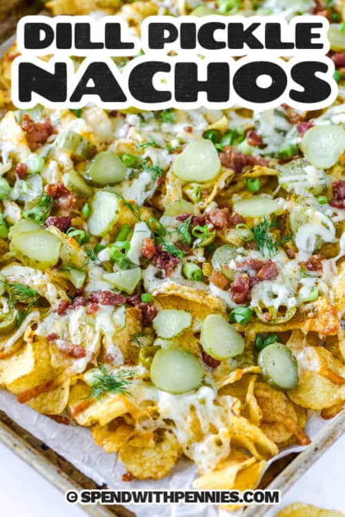 Dill pickle nachos are perfect for pickle lovers looking for something fun and flavorful to share. Layers of crunchy chips, melty cheese, and pickles come together with savory bacon and a hint of garlic. A creamy dipping sauce brings it all together for the ultimate snack. #spendwithpennies dill pickle nachos on a pan with text