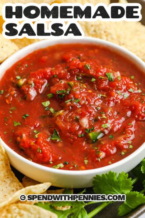 Homemade salsa is bursting with fresh flavor from canned tomatoes, jalapeño, lime, and cilantro. It’s quick to make in a food processor with just a few pulses and tastes even better after chilling. With a zesty mix of garlic, cumin, and onion, this salsa is bold, bright, and perfect for dipping or topping your favorite dishes. Ready in minutes and full of flavor! #spendwithpennies fresh Homemade Salsa in a bowl with chips