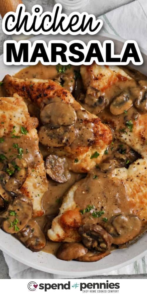 With just one skillet and a few basic ingredients, Chicken Marsala comes together fast and easy. Thin chicken breasts cook quickly, and the sauce is made with sautéed mushrooms, wine, and butter. The secret is letting the mushrooms brown and release their flavor before adding the liquids. Serve this dish over your favorite pasta or rice. #spendwithpennies close up of Chicken Marsala in pan with a title