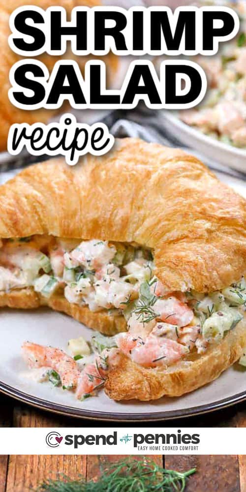 This shrimp salad recipe makes a deliciously cool and creamy lunch or light dinner. It’s packed with chopped shrimp, fresh cucumber, celery, and just enough dressing to pull it all together. Old Bay and lemon juice bring a zesty flavor that goes great on greens or stuffed into a soft roll. Simple, fresh, and easy to love, this recipe is a keeper all year round. #spendwithpennies Shrimp Salad recipe on a croissant with a title